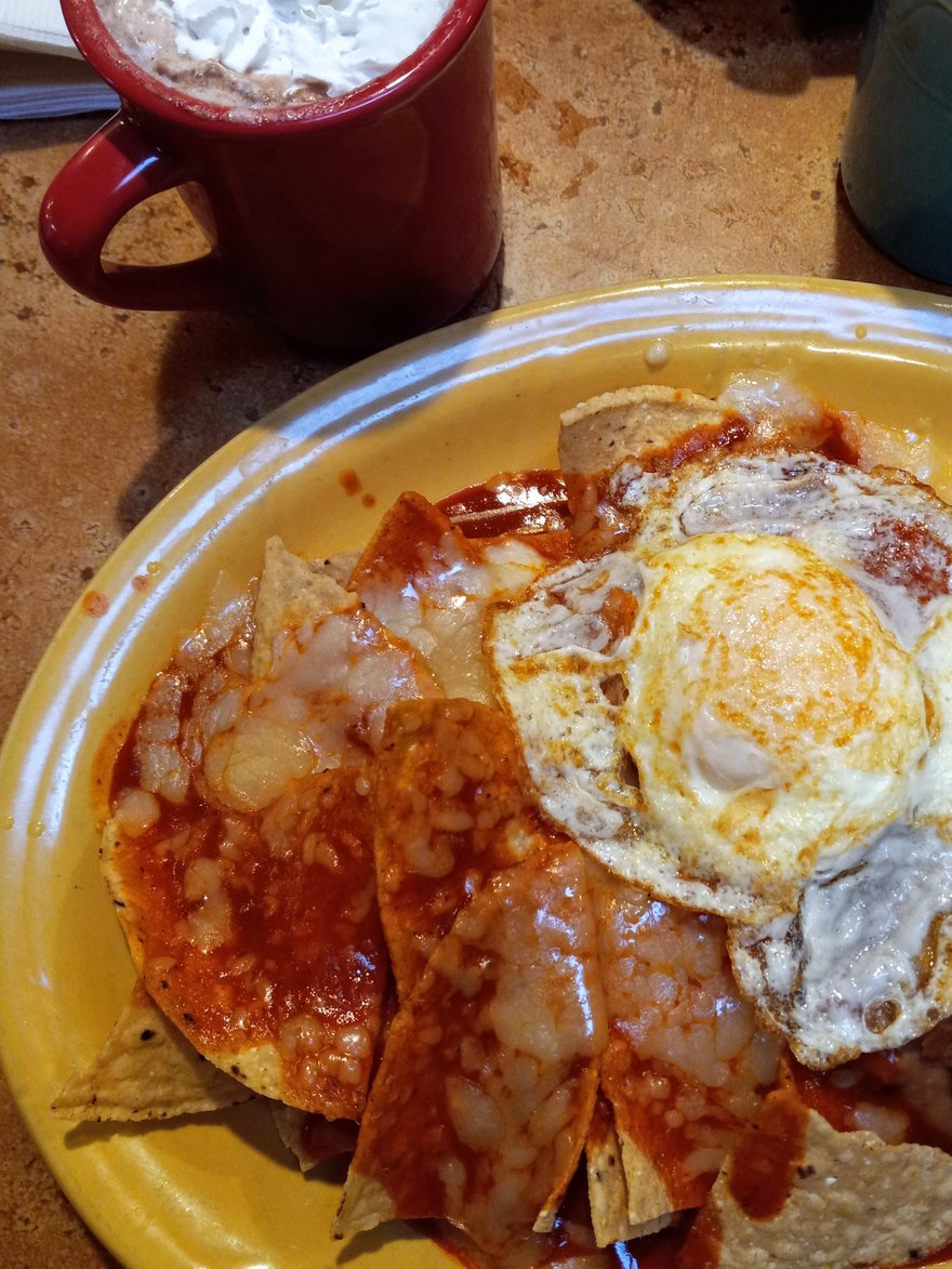 This is a New Mexican breakfast called Chilaquiles. It is a simple and inexpensive meal that can be found in a few places like LITTLE ANITAS' where I am now. It is made with 