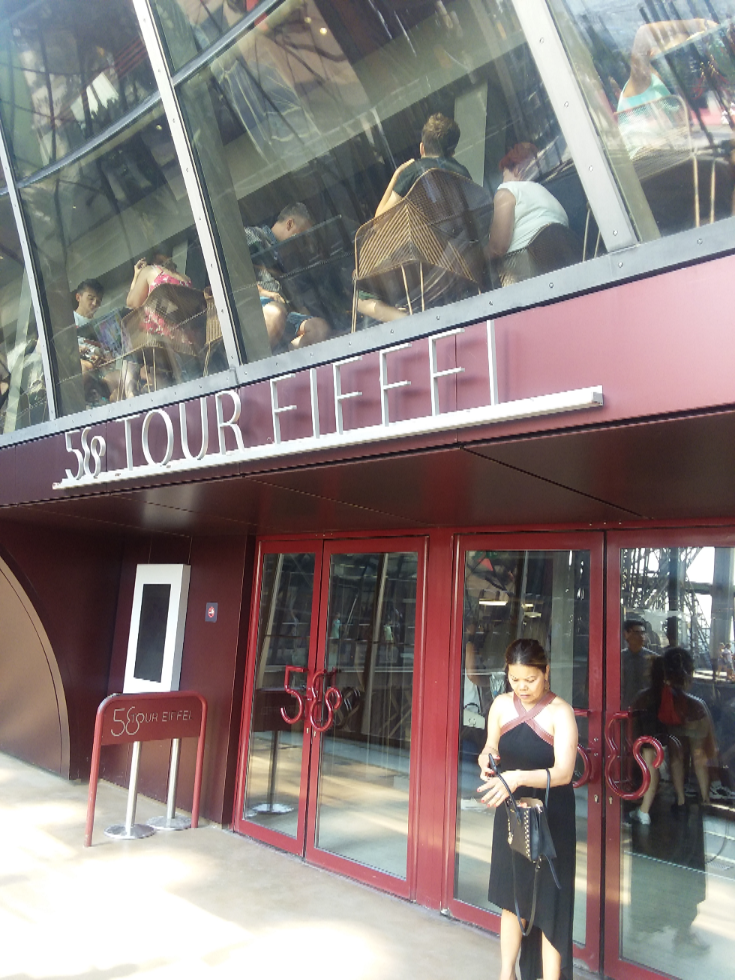 Farida is standing in front of the entrance of 58 Tour Eiffel which is the restaurant on the first level of the Eiffel Tower. This is the entrance that one enters to arrive at the hostess desk which is just inside the door. Show them your reservation and get seated fairly quickly. The food is good. Service was very professional and efficient for us. They have fixed menus with 4 choices of entrés so we ordered each entré. They have 3 choices of main courses so we chose each main with 2 of the duck meals. They have about 5 or 6 dessert options so we chose 4 of them.