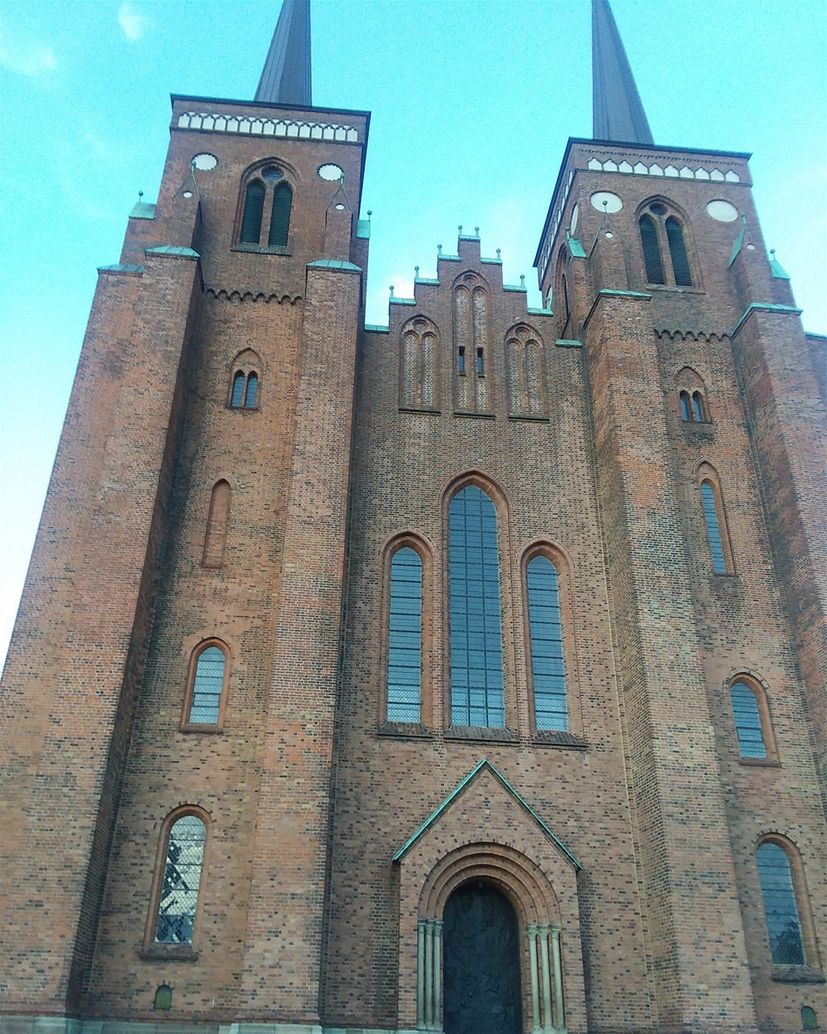 The facade of Roskilde Cathedral. The Kingdom of Danmark was founded in Roskilde. Roskilde was the capital of Danmark from 1150-1443. There are 39 royal tombs in this cathedral. It is still the burial site of Danish monarchs. It is a World Heritage Site. .