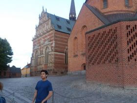 In front of the mausoleum of Roskilde Cathedral with the Yellow Palace (Royal Mansion) further down the very large square.
